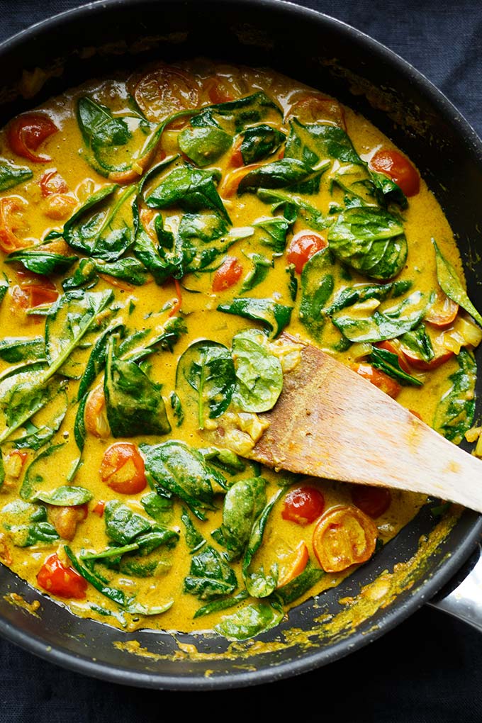 Werbung. Kokos-Curry mit Spinat und Tomaten. Dieses 30-Minuten Rezept ist schnell, vegan und unglaublich cremig! - Kochkarussell.com