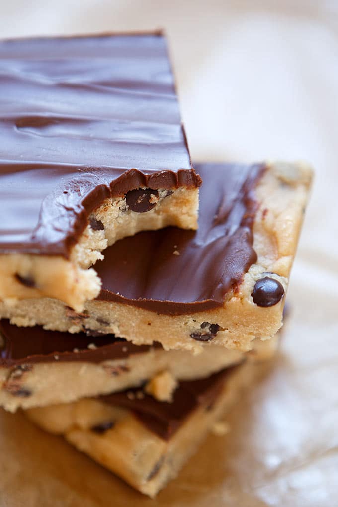 Werbung. No-Bake Chocolate Chip Cookie Dough Bars! Dieses 8-Zutaten Rezept ist dekadent reichhaltig, vegan und unfassbar lecker. Roher Keksteig überzogen mit geschmolzener Schokolade. Kommt garantiert gut an! - Kochkarussell.com #cookiedoughbars #cookiedough #vegan #dessert #vegandessert #chocolate