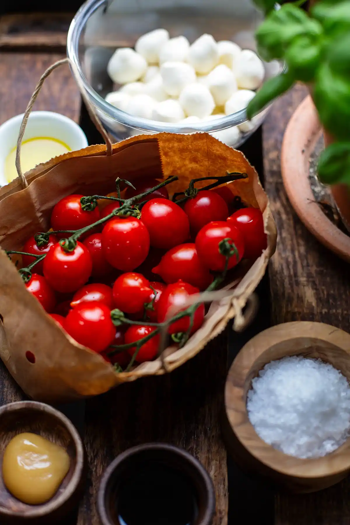 Zutaten für Tomaten-Mozzarella-Salat: Tomaten, Mozzarella, Basilikum, Essig, Öl und Honig